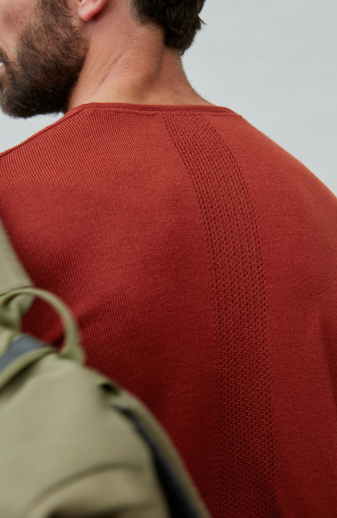 red merino wool sweater with perforations by Paul James 
