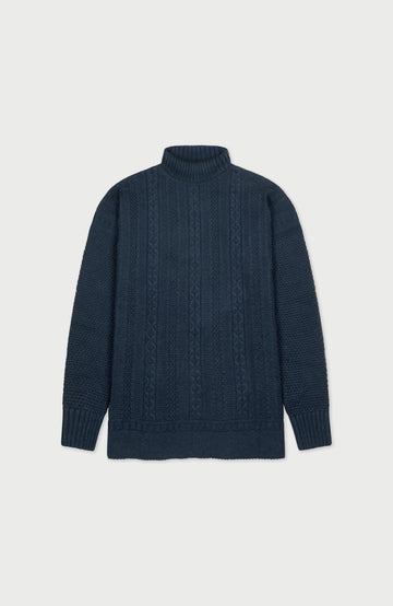 Dark blue cable paul james turtle neck knit gansey on a light gray background