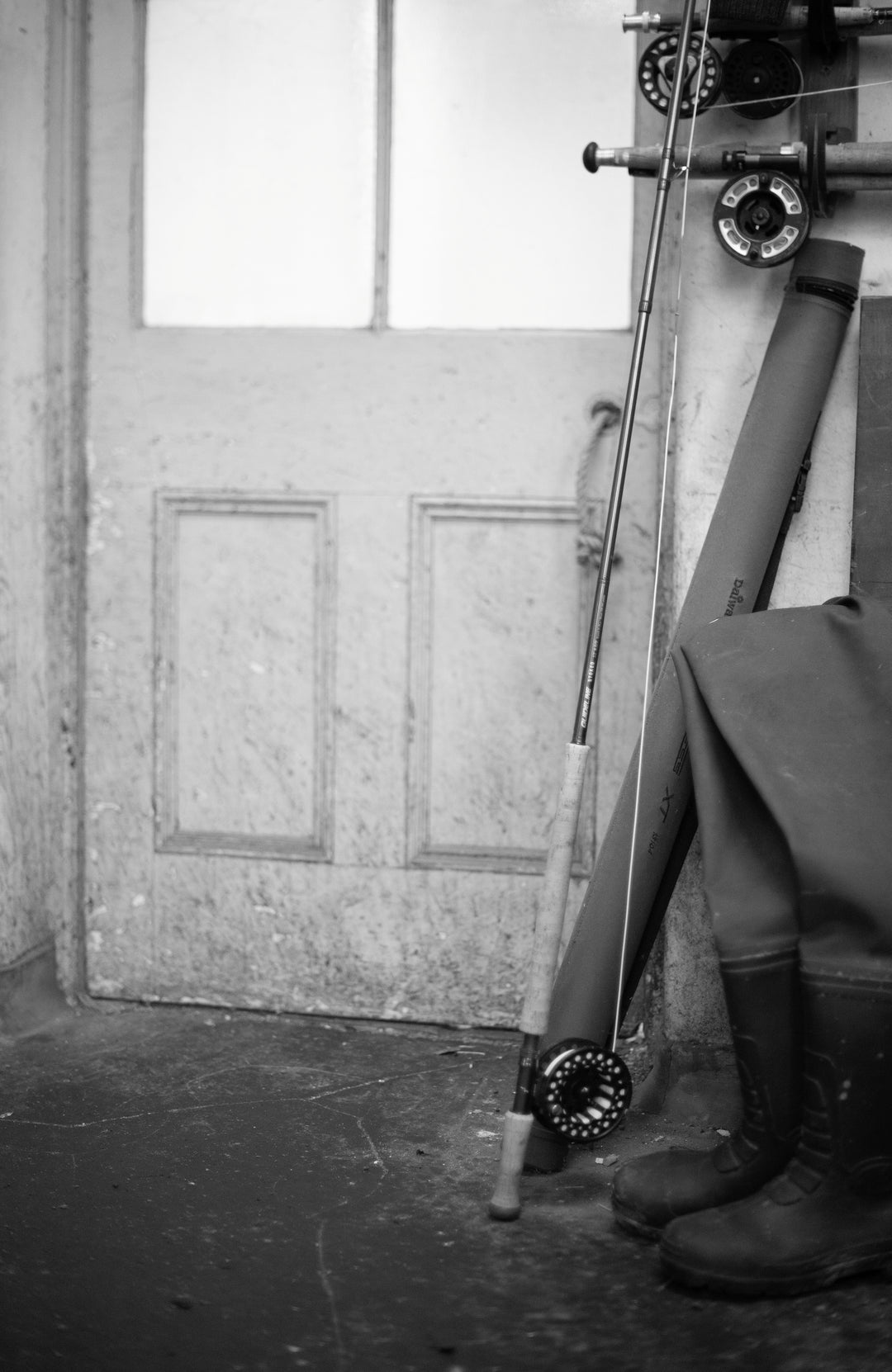 Fishing rod and reel against a wooden door