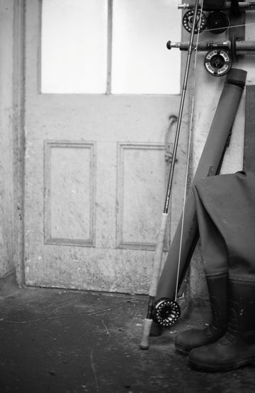 Fishing rod and reel against a wooden door