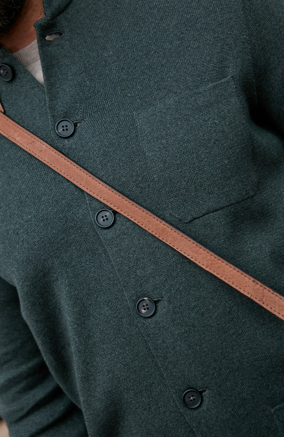 Green mandarin coat with brown trim and button details