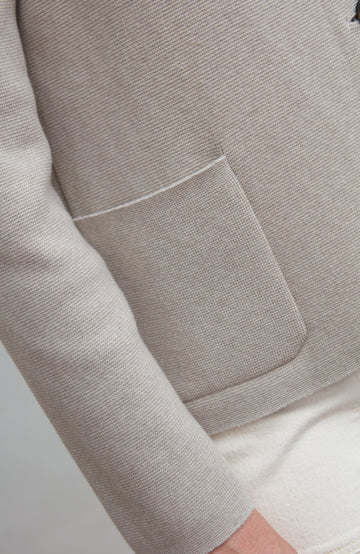 Close-up of a gray nehru jacket with a pocket on a light gray background