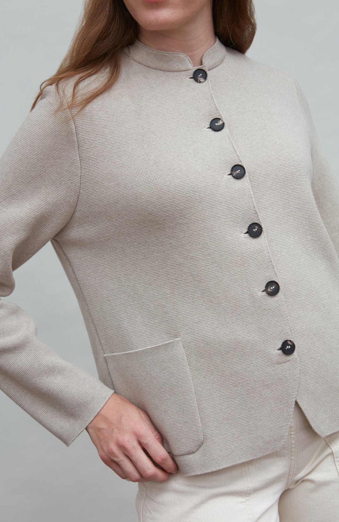 Beige jacket with black buttons on a plain background paul james nehru