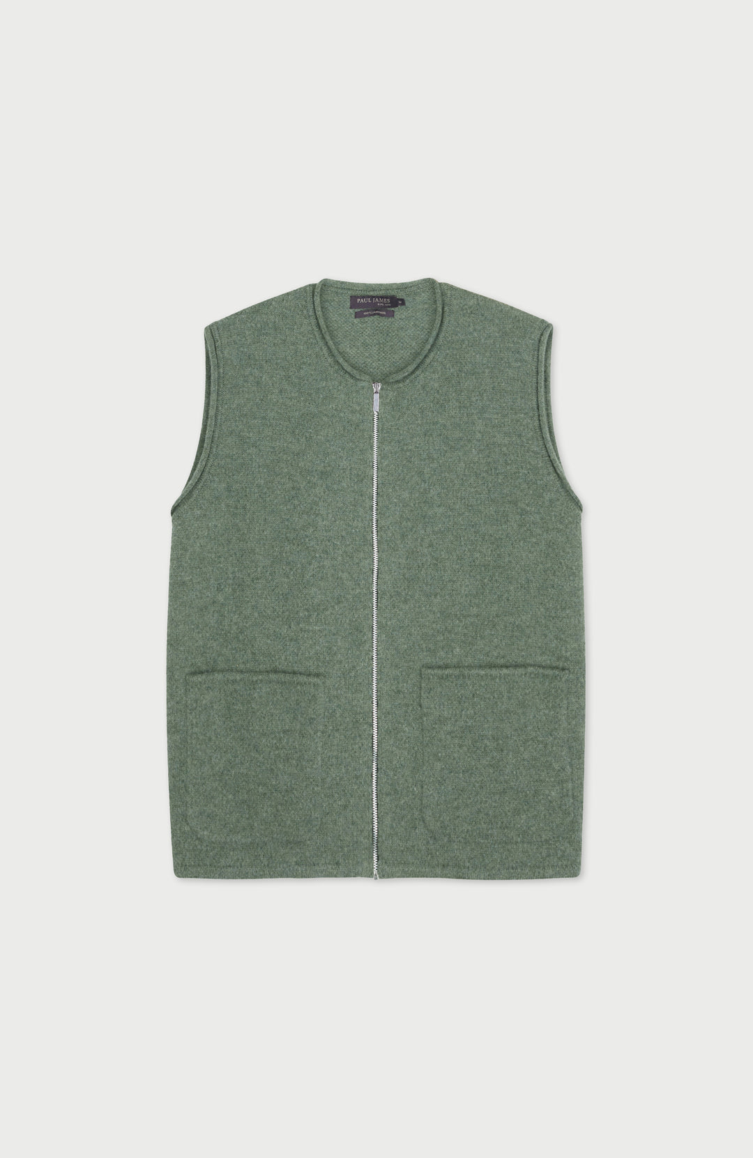 Green wool gilet by paul james with a zipper on a light gray background