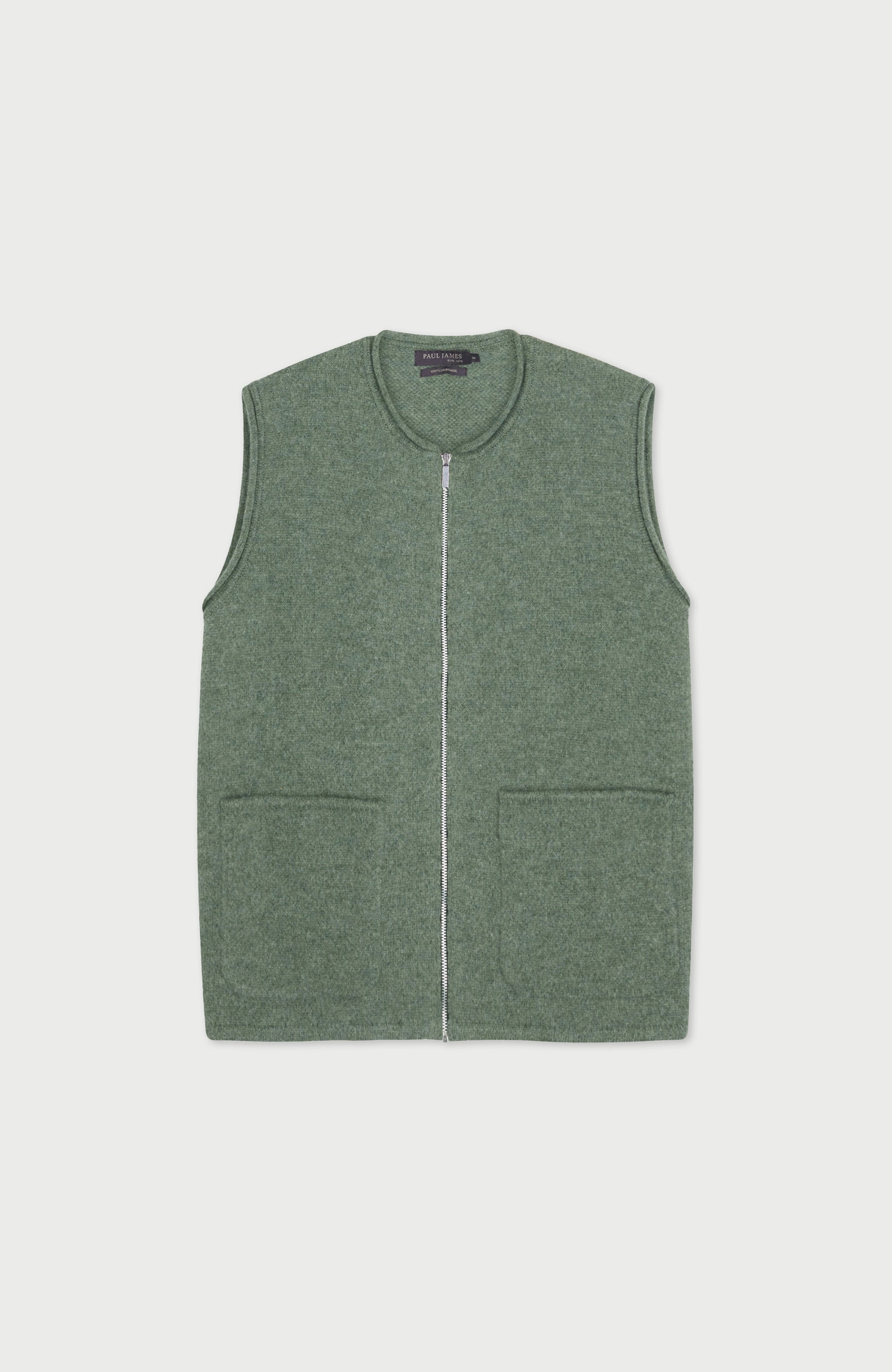 Green wool gilet by paul james with a zipper on a light gray background