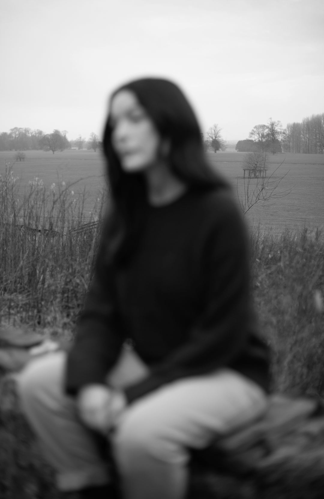 women sitting on wall in paul james jumper