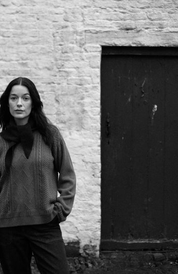 Green women's fisherman's gansey sweater with rolled edge trims by Paul James Knitwear.
