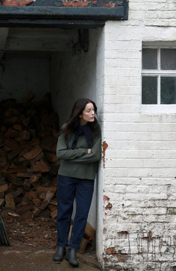 Green women's fisherman's gansey sweater with rolled edge trims by Paul James Knitwear.