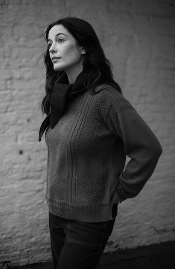 Green women's fisherman's gansey sweater with rolled edge trims by Paul James Knitwear.