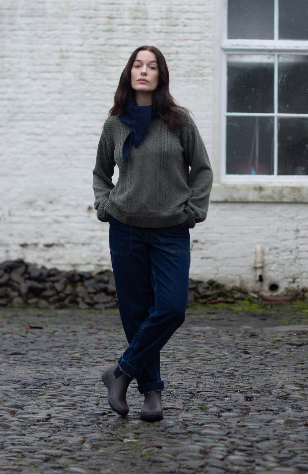 Green women's fisherman's gansey sweater with rolled edge trims by Paul James Knitwear.
