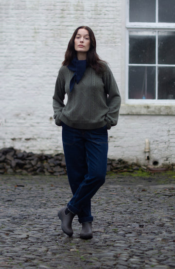 Green women's fisherman's gansey sweater with rolled edge trims by Paul James Knitwear.