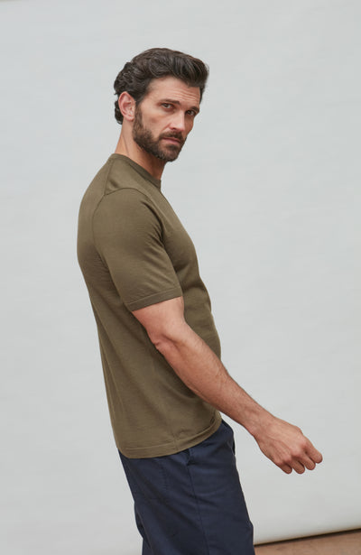 man wearing green merino wool t-shirt