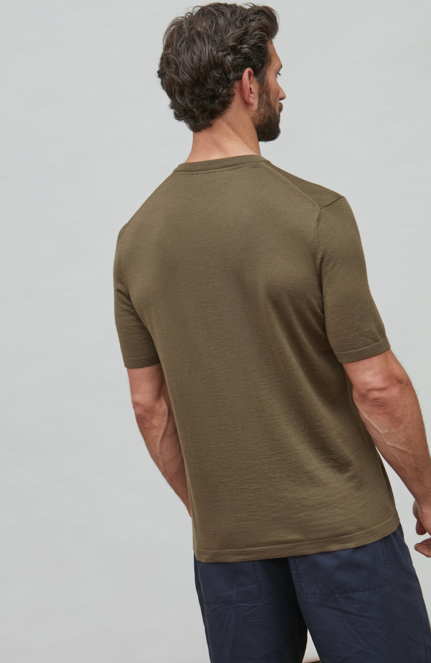 man wearing green merino wool t-shirt