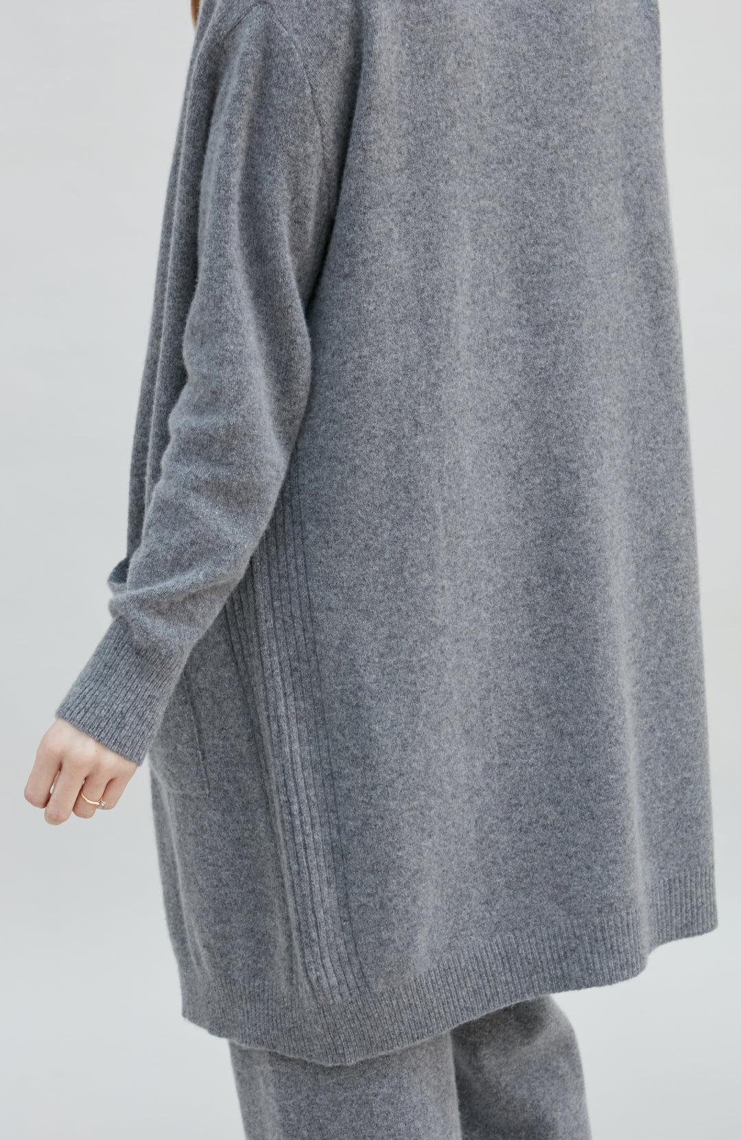 Gray wool womens cardigan and pants set on a plain background by Paul James