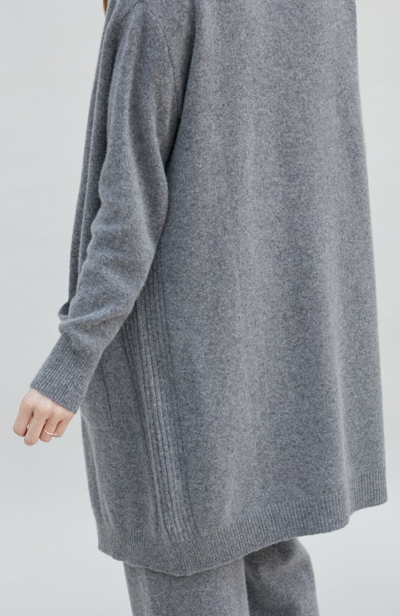 Gray wool womens cardigan and pants set on a plain background