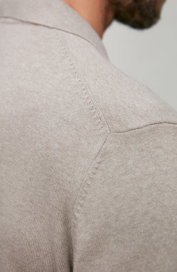 Close-up of a beige shirt with a blurred background
