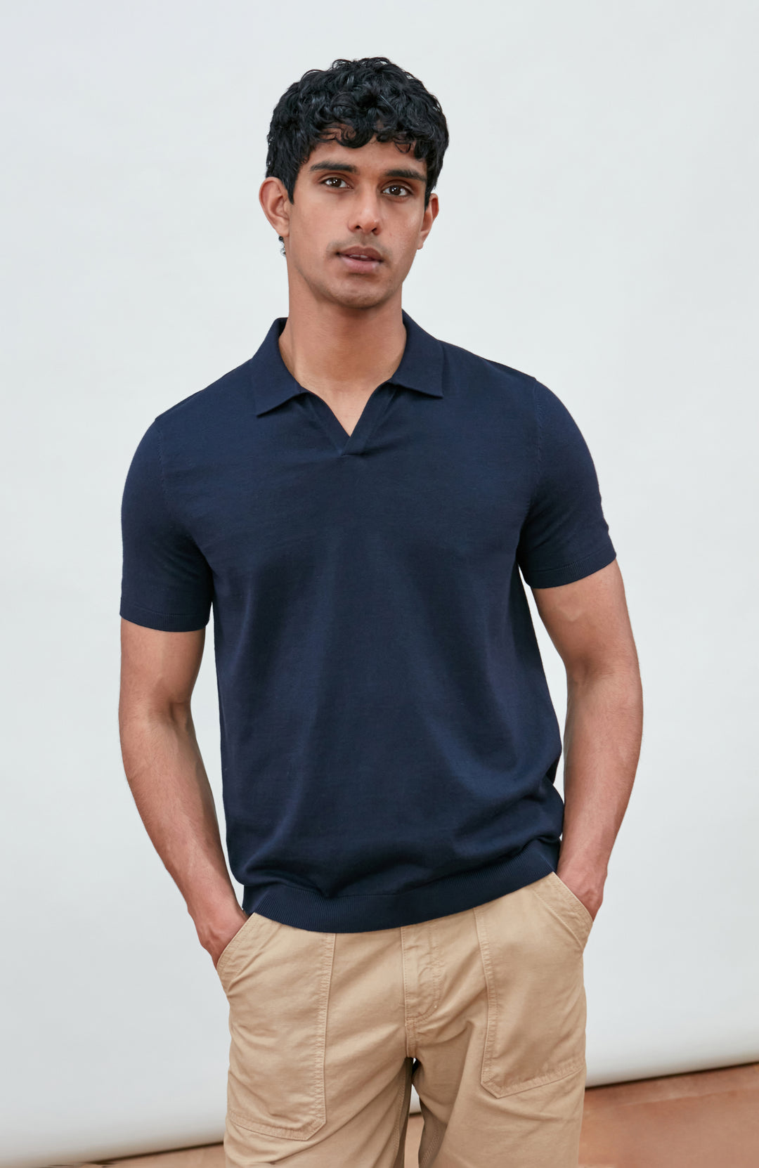Navy men's short-sleeve polo shirt by Paul James Knitwear, buttonless