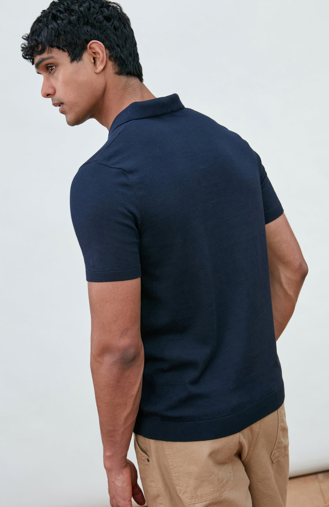 Navy men's short-sleeve polo shirt by Paul James Knitwear, buttonless
