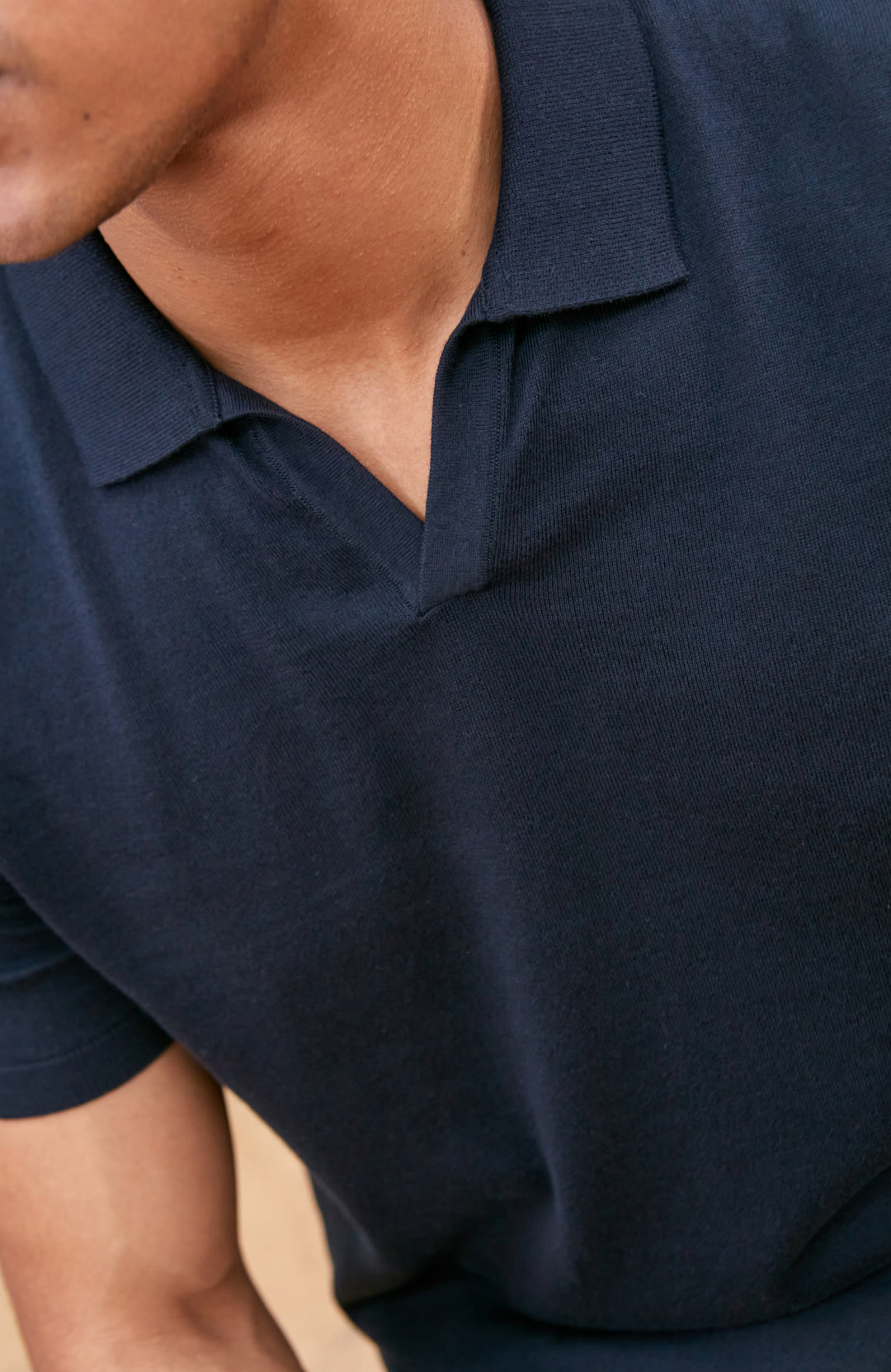 Navy men's short-sleeve polo shirt by Paul James Knitwear, buttonless