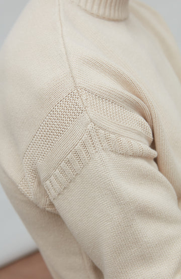 Close-up of a guernsey sweater with intricate knitting pattern