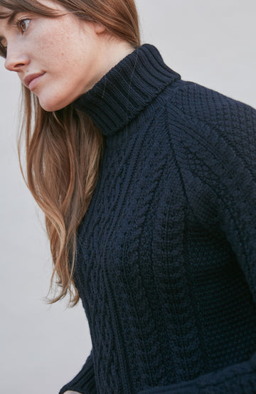 Womens wearing navy chunky wool cable sweater by Paul James