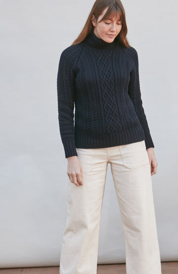 Womens wearing navy chunky wool cable sweater by Paul James