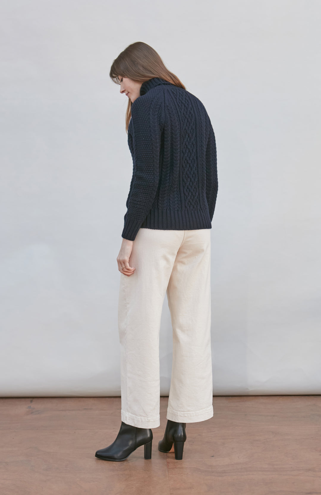 Womens wearing navy chunky wool cable sweater by Paul James