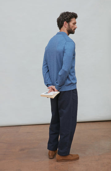 Man wearing a denim blue merino wool button-up shirt against a gray background by Paul James