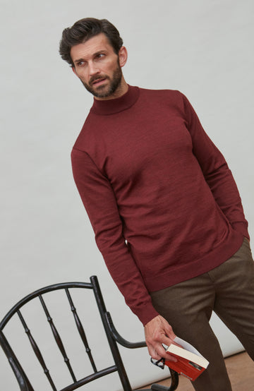 Man wearing a red merino wool mock turtleneck sweater by Paul James