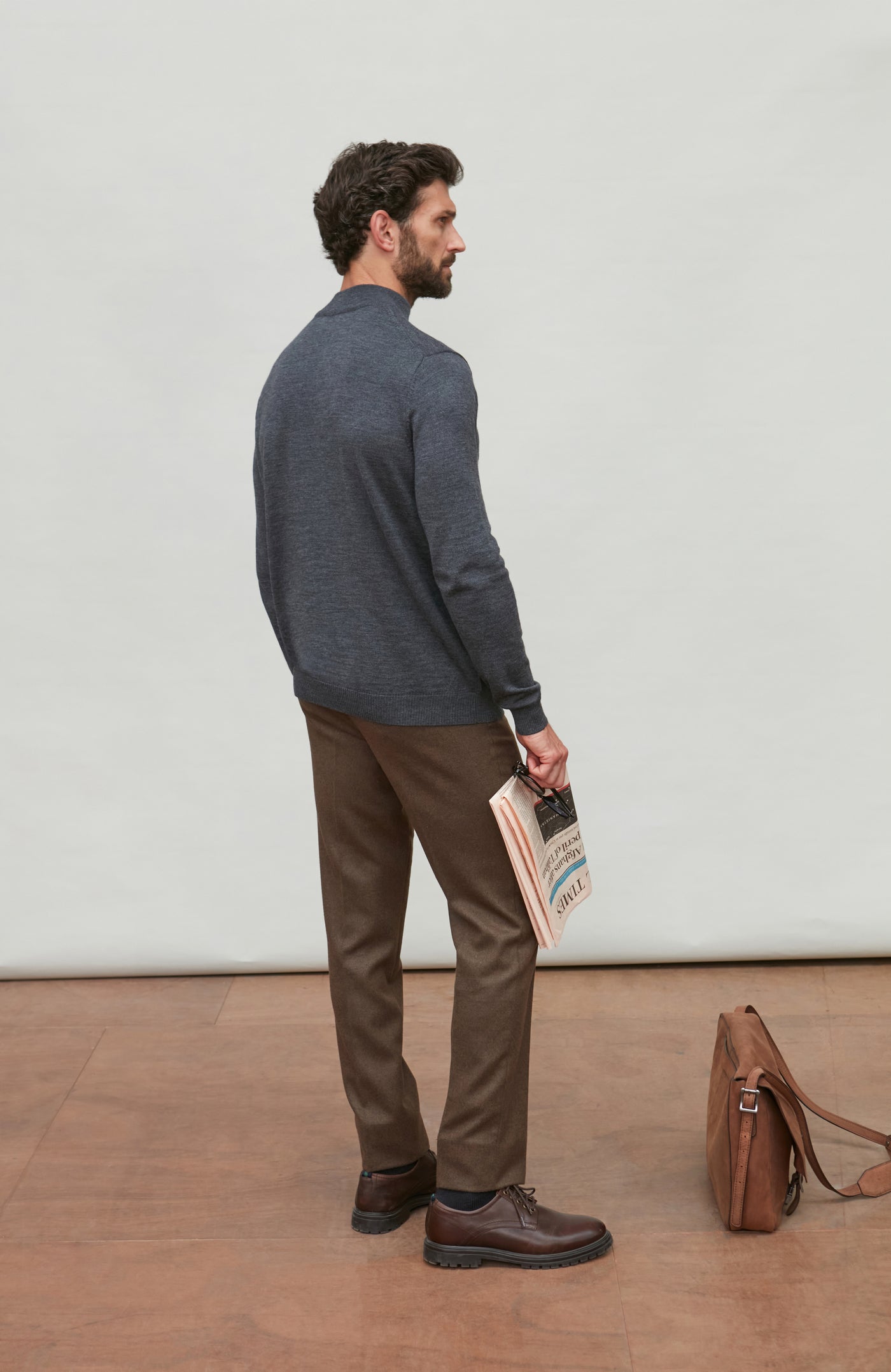 Man wearing a dark gray merino wool turtle neck sweater