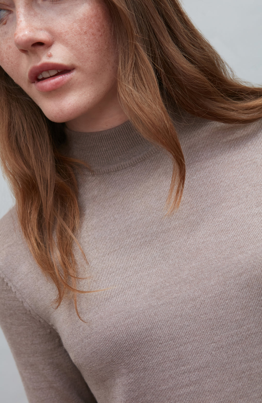 Beige women's extra fine merino wool mock neck jumper with back detail by Paul James Knitwear