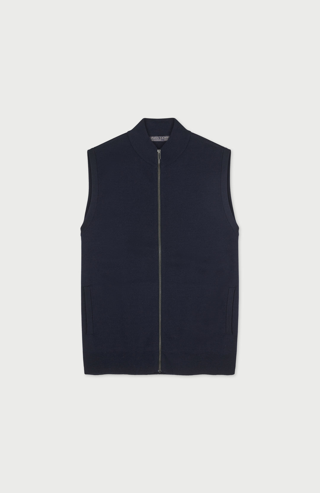 A mens sleeveless zip-front merino wool vest by Paul James Knitwear in a very dark navy blue, shown flat against a light gray background.