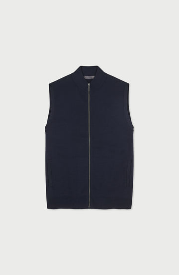 A mens sleeveless zip-front merino wool vest by Paul James Knitwear in a very dark navy blue, shown flat against a light gray background.