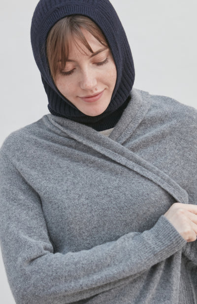woman wearing a navy merino cashmere balaclava against a plain background