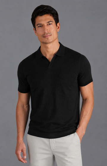 Man wearing a black buttonless polo shirt by Paul James Knitwear